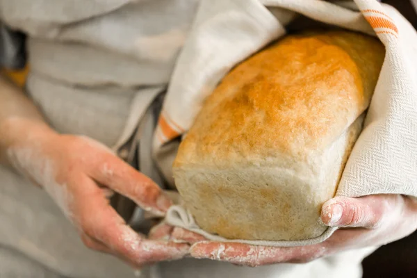 Young baker with sourdough bread — Stock Photo, Image