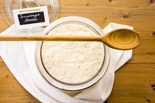 Sourdough starter in large glass jar — Stock Photo, Image