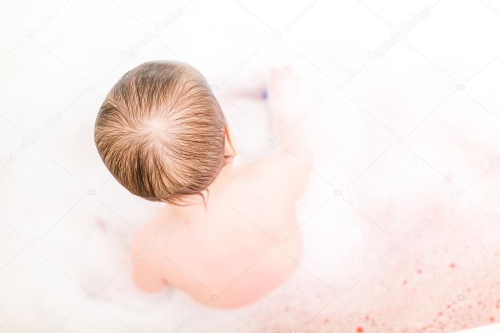 Cute baby girl taking a bath