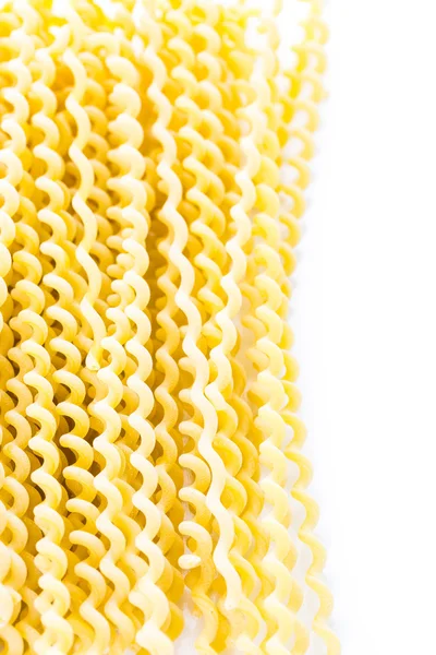 Organic yellow long pasta spirals — Stock Photo, Image