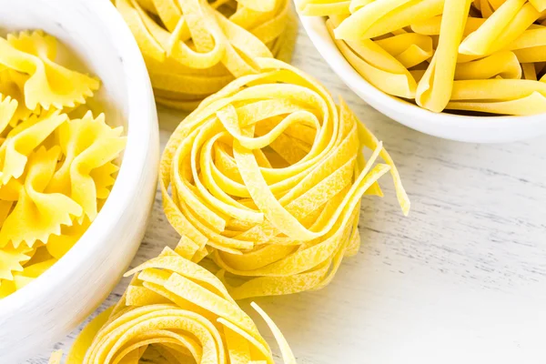 Variety of yellow dry pasta — Stock Photo, Image