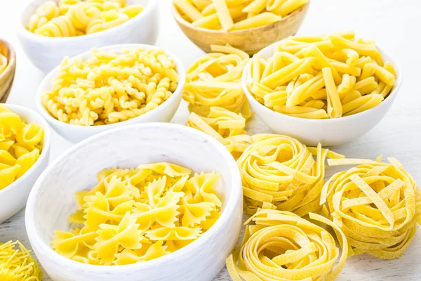 Variety of yellow dry pasta — Stock Photo, Image