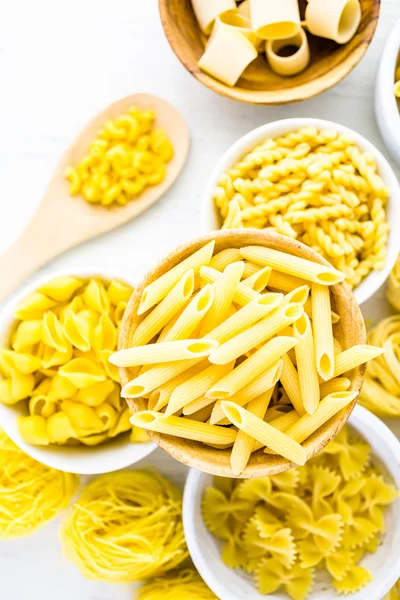 Variety of yellow dry pasta — Stock Photo, Image