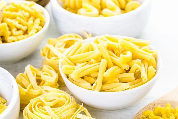 Variety of yellow dry pasta — Stock Photo, Image