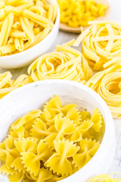 Variety of yellow dry pasta — Stock Photo, Image