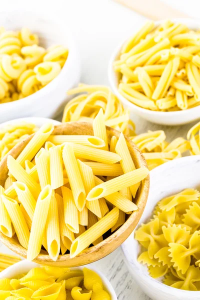 Variety of yellow dry pasta — Stock Photo, Image