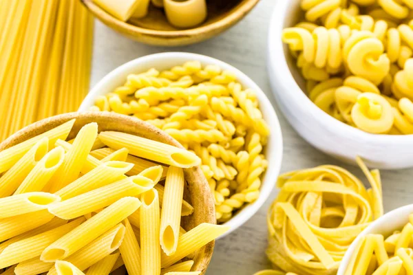 Variety of yellow dry pasta — Stock Photo, Image