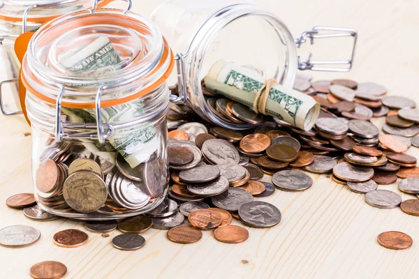 Saving money into glass jar — Stock Photo, Image