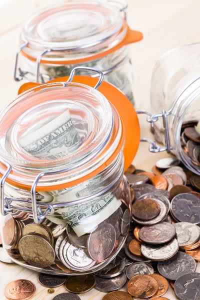 Saving money into glass jar — Stock Photo, Image