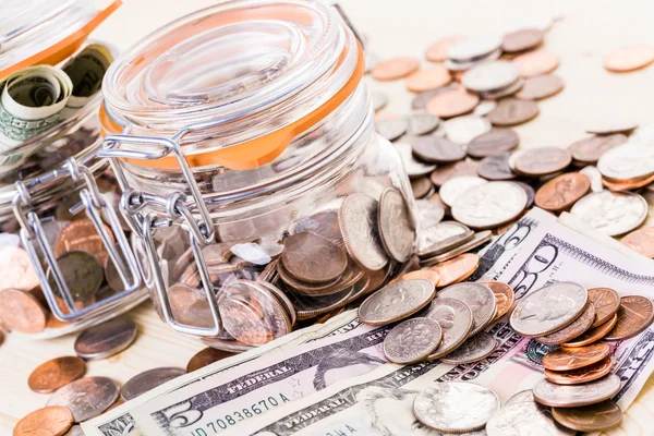 Saving money into glass jar — Stock Photo, Image