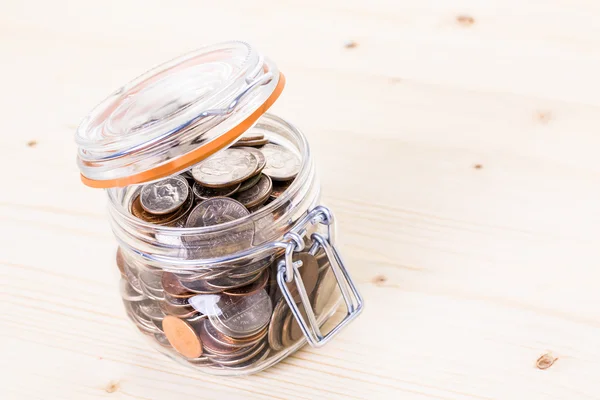 Saving money into glass jar — Stock Photo, Image