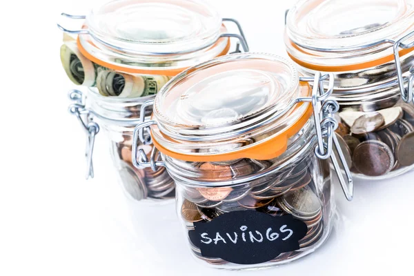 Saving money into glass jar — Stock Photo, Image