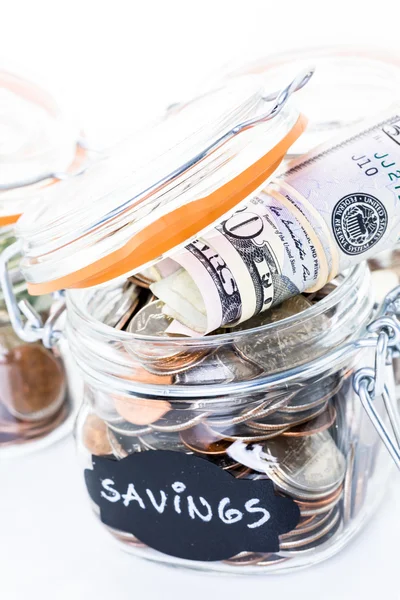 Saving money into glass jar — Stock Photo, Image