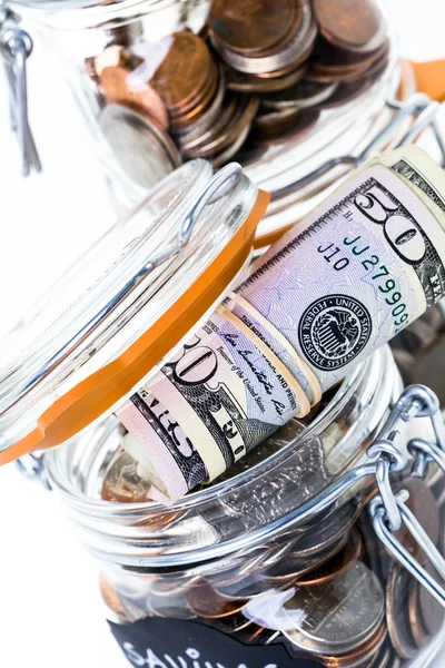 Saving money into glass jar — Stock Photo, Image