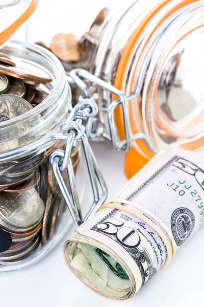 Saving money into glass jar — Stock Photo, Image