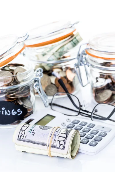 Saving money into glass jar — Stock Photo, Image