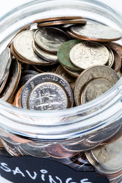 Saving money into glass jar — Stock Photo, Image