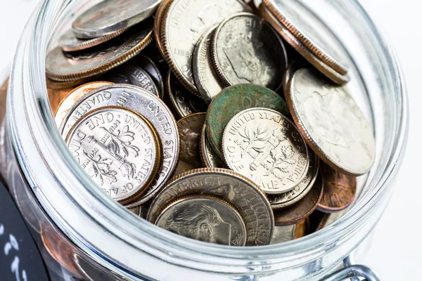 Saving money into glass jar — Stock Photo, Image