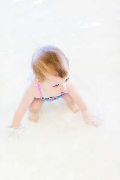 Baby girl at indoor swimming pool — Stock Photo, Image