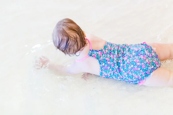 Baby girl at indoor swimming pool — Stock Photo, Image