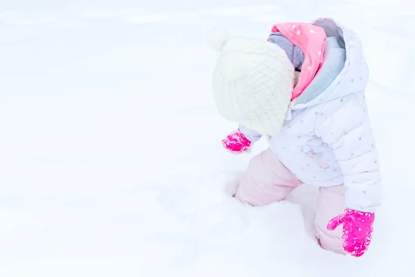 Baby girl and fresh snow — Stock Photo, Image