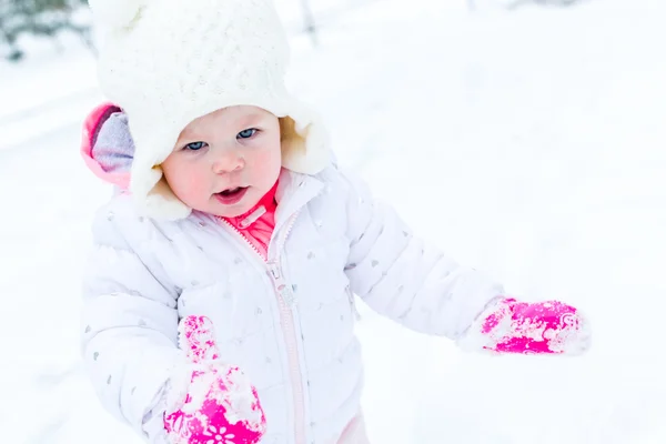 Baby girl and fresh snow — Stock Photo, Image