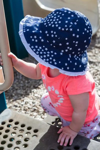 Toddler girl playing on tot lot — Stock Photo, Image