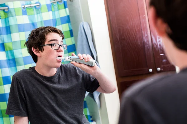 Teenage boy brushing teeth — Stock Photo, Image