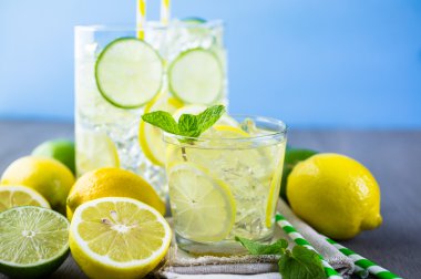 Water with fresh citrus fruits and ice. clipart