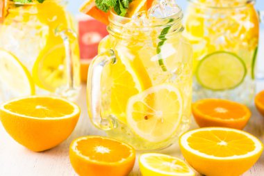 Water with fresh citrus fruits and ice clipart