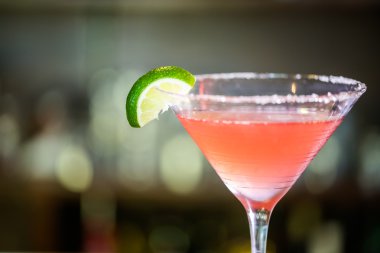 Cosmopolitan cocktail at bar clipart