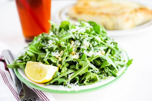 Arugula salad with pine nuts — Stock Photo, Image