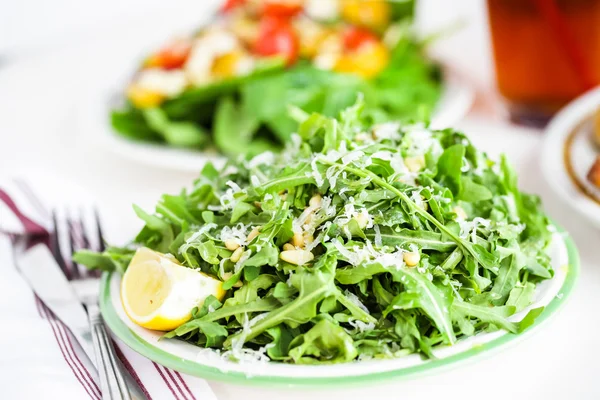 Arugula salad with pine nuts — Stock Photo, Image