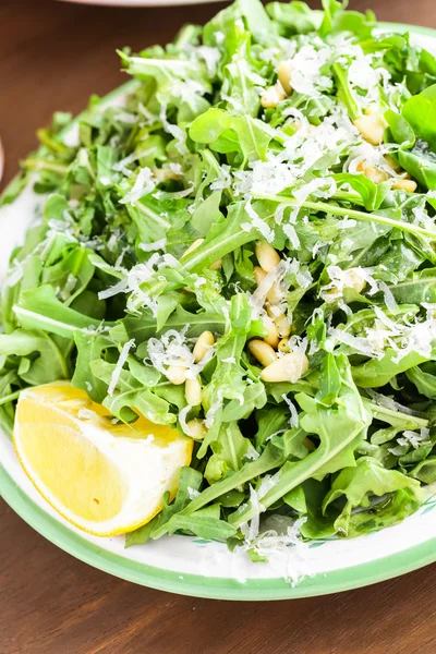 Arugula salad with pine nuts — Stock Photo, Image