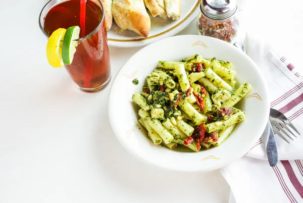 Pesto pasta with chicken in the plate — Stock Photo, Image