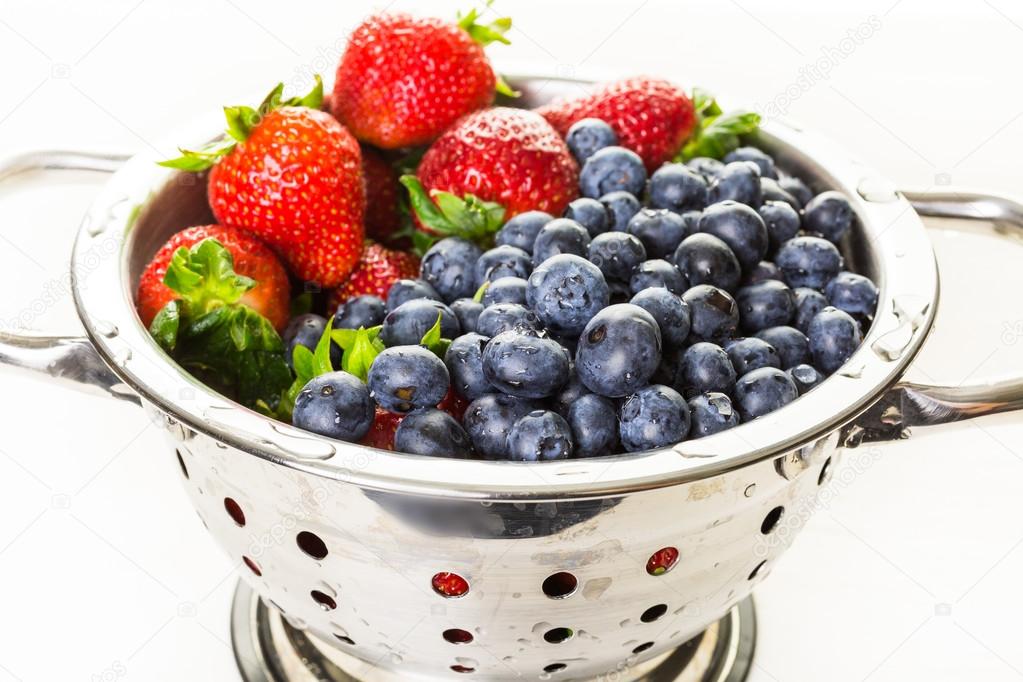 Colander with washed organic berries.