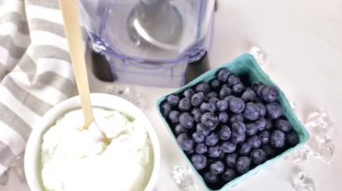 Ingredients for smoothie with plain yogurt and berries