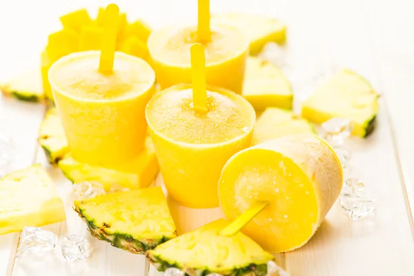 Popsicles made with mango, pineapple and coconut milk — Stock Photo, Image