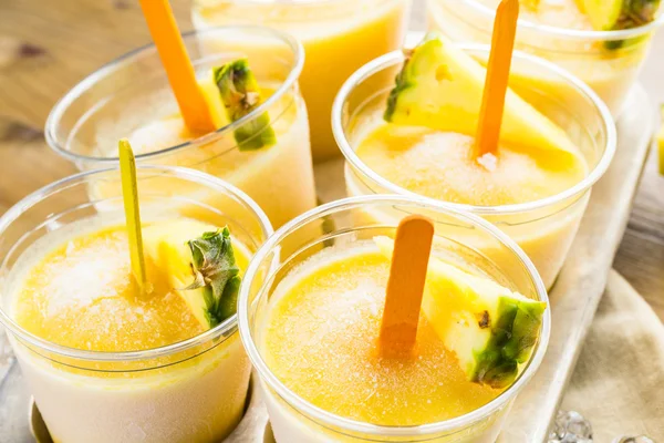 Popsicles made with mango, pineapple and coconut milk — Stock Photo, Image