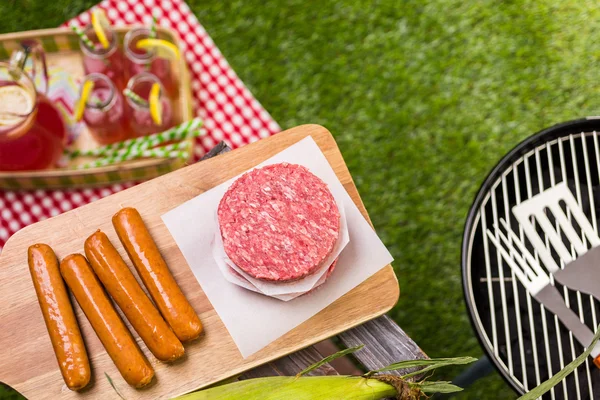 Summer picnic with small charcoal grill and hotdogs — Stock Photo, Image