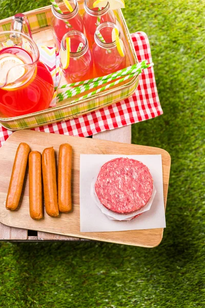 Summer picnic with small charcoal grill and hotdogs — Stock Photo, Image