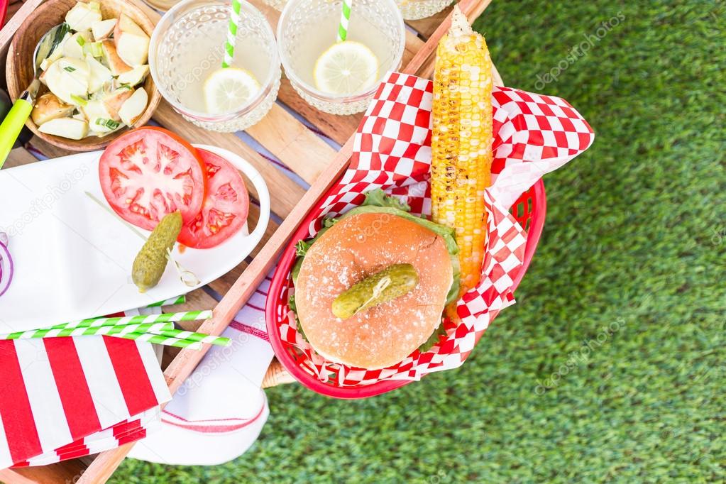 Small summer picnic with lemonade and hamburgers
