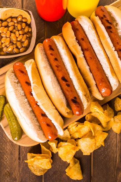 Grilled hot dogs on a white hot dog buns