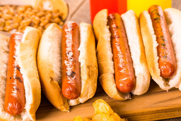 Grilled hot dogs on a white hot dog buns