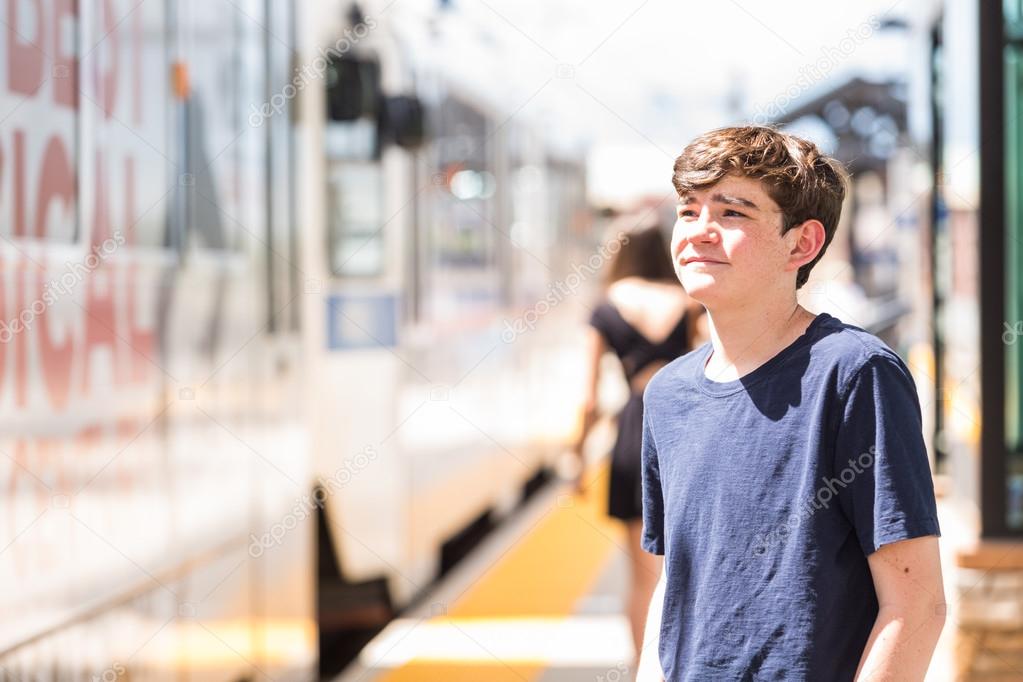 Teenage boy at the light rail station