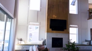 Bu oturma odası yüksek tavanlar ve geniş pencerelerle böbürlenerek geniş ve aydınlık bir ortam yaratıyor. Zarif şömine sofistike alana sıcak bir dokunuş ekler, rahatlamak için mükemmeldir..