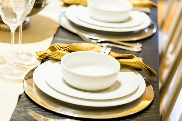 Table set with plates and silverware — Stock Photo, Image