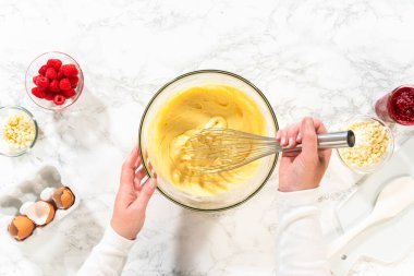 Düz yatıyordu. Bir çırpma makinesiyle, ölçülen malzemeler bir araya gelir. Pasta hamurunu bu lezzetli keke hazırlamak için ustalıkla karıştırılır..