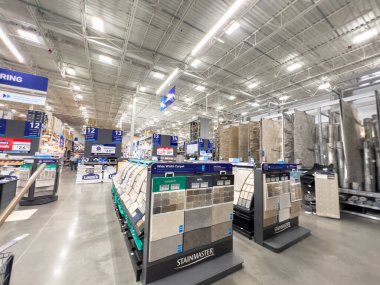 Parker, Colorado, ABD-26 Mayıs 2025 - Geniş bir döşeme ve halı mağazası koridorunda uzun bir manzara. Halı ve döşeme malzemeleri her iki tarafta da ışıklandırma var..