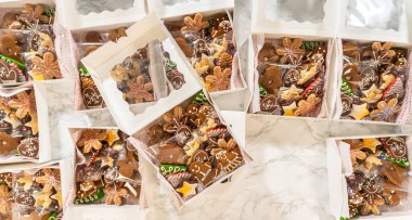 İçinde zencefilli ekmek adamlar, eldivenler, yıldızlar ve ağaçların da bulunduğu güzel dekore edilmiş Noel kurabiyeleriyle dolu tatil temalı hediye kutuları. Her kurabiye ferahlık için ayrı ayrı paketlenir.